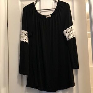 Black tunic with white crochet detail on sleeve